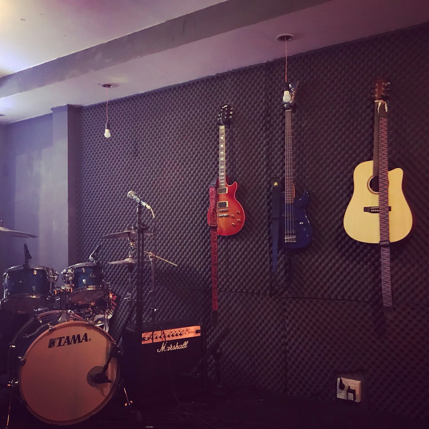 Musical instruments displayed in a prepared rehearsal studio.
